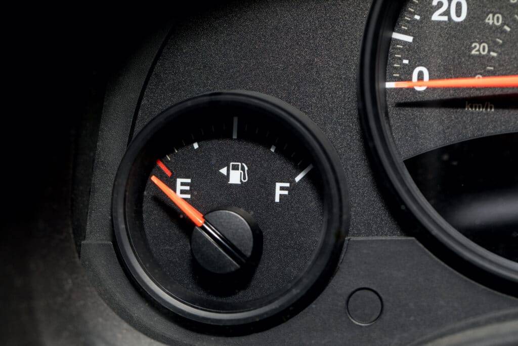 car shipping close-up picture of a fuel gauge and speedometer both at zero