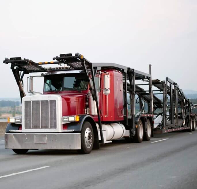 Red Semi Truck Driving from Right to Left with Empty Open Car Trailer | National Transport Services