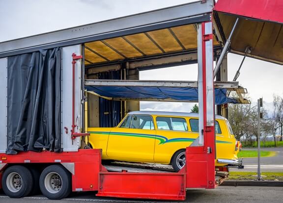 Yellow Ckassic Car Being Loaded on Enclosed Trailer | National Transport Services