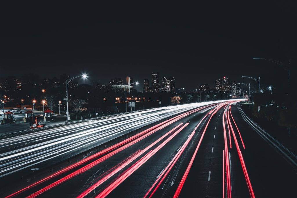 The highway at night with speeding traffic. with our Cross country car shipping service, we provide three options: Standard car shipping, Priority car shipping, and expedited car shipping. Open auto transport is the most common way to ship a car.