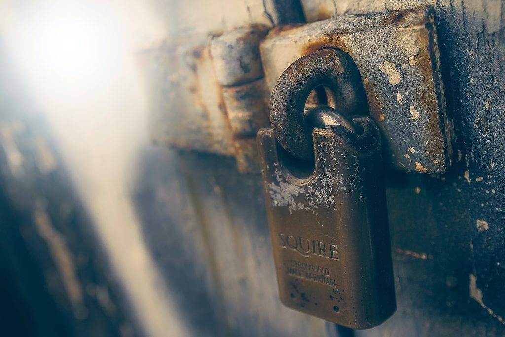 An up-close picture of a padlock. Covered car transport is the safest option.