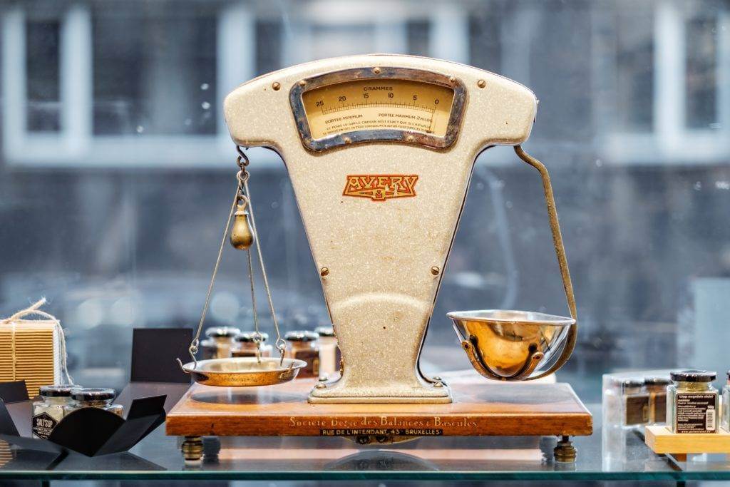A vintage scale on a glass table. Car Shipping.