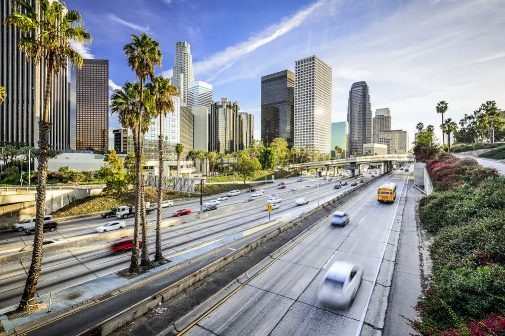 California highway and cityscape. This blog will go over The Best Car Shipping Companies in California.