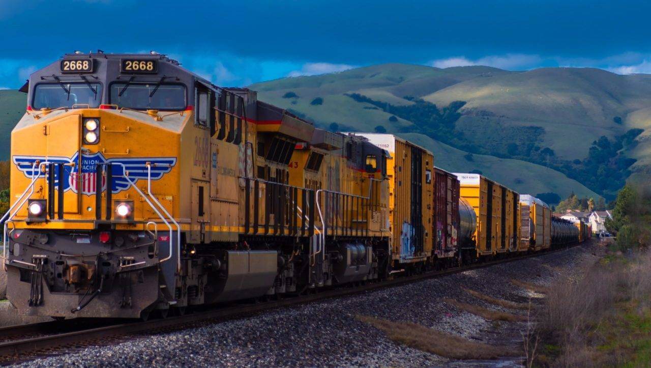 A Union Pacific Engine train pulling rail cars. Are you looking to ship a car by train? Read this article to learn all about it. There are several ways the auto transport industry can service you.