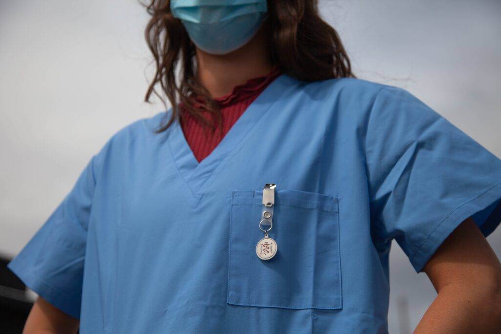 A photo of a nurse from the neck down to her waist.