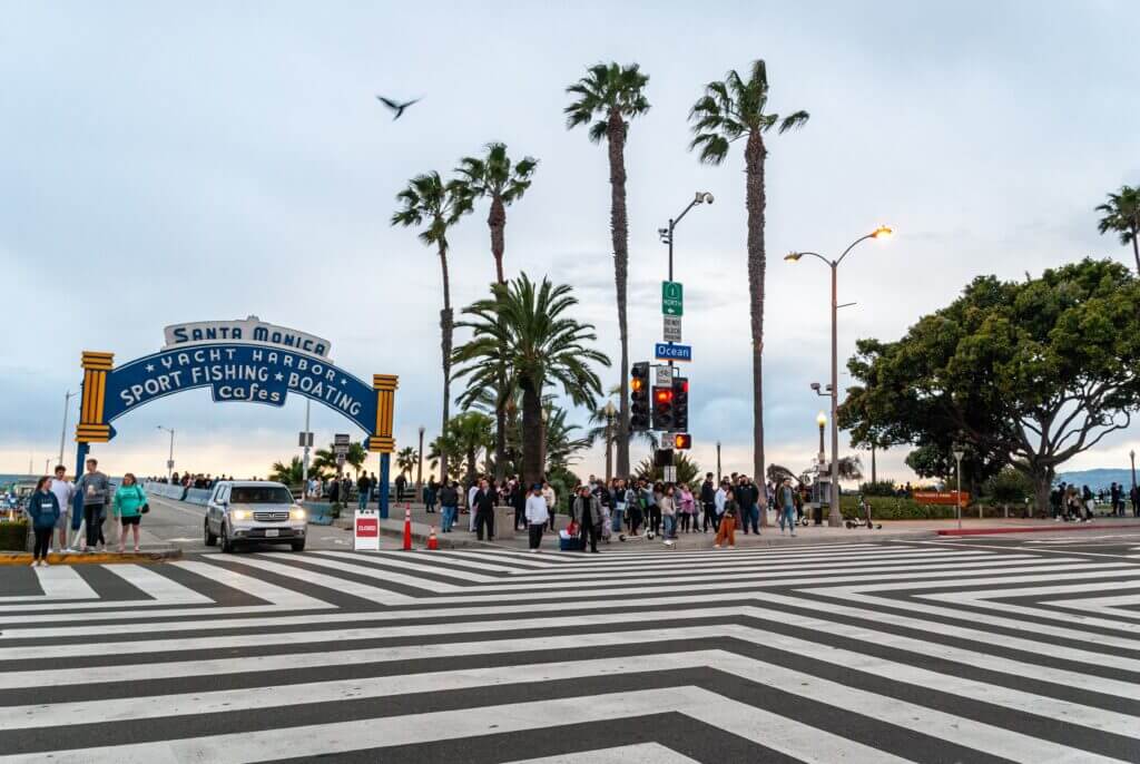 Santa Monica, California beach pier entrance. We can car shipping California to New York as well—San Diego to Buffalo or San Francisco to Queens, NY.