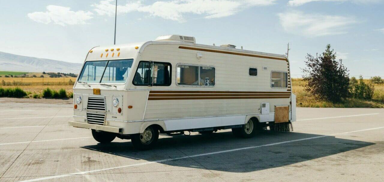 An old RV parked on the side of the road. Shipping an RV